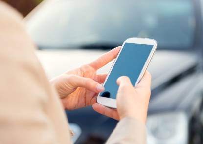 A close up of a pair of hands holding a phone. The person holding the phone appears to be texting.